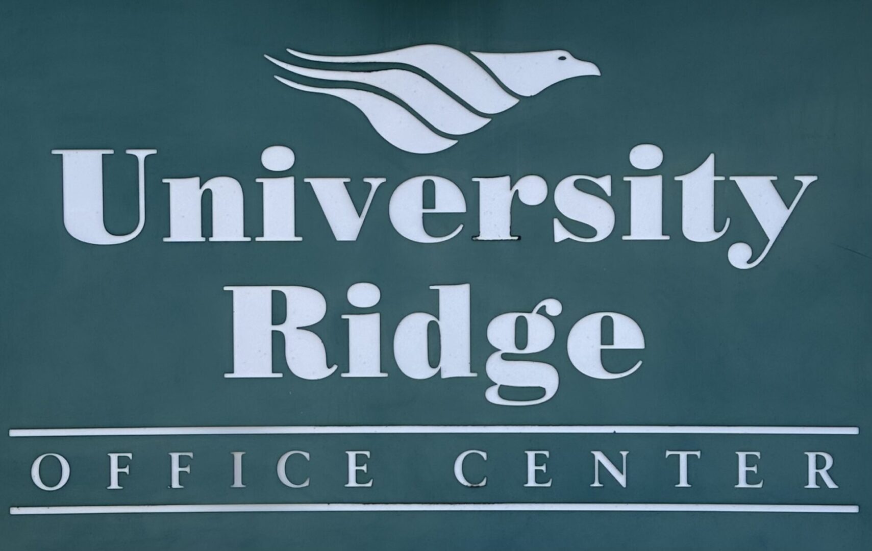 A sign for the university ridge office center.